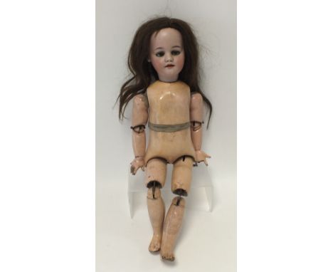 A bisque headed doll by Simon and Halbig, the doll with brown flirty eyes and with open mouth revealing four upper teeth, the