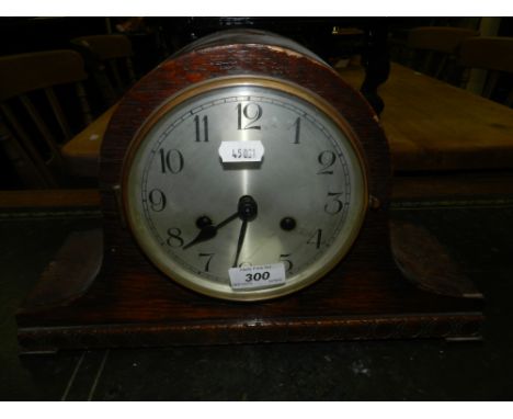 A Napoleon hat shape oak cased mantle clock
