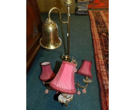 A brass table lamp with bell shaped shade and a three branch ceramic and gilt metal chandelier 