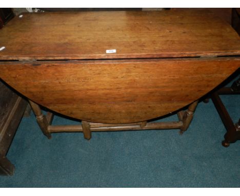 An 18th century oak gate-leg dining table with two end frieze drawers.**