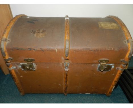 A brown canvas travel trunk, bears remnants of some paper labels together with a further trunk