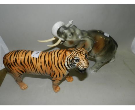 A Beswick Tiger, modelled with teeth bared along with a model of an elephant with trunk raised