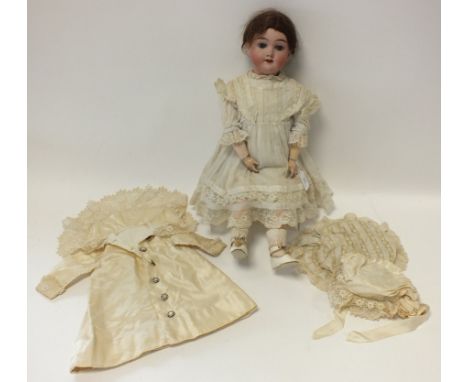 A bisque headed doll by Handwerck, Germany, the doll with sleeping blue eyes and open mouth revealing four upper teeth, dress