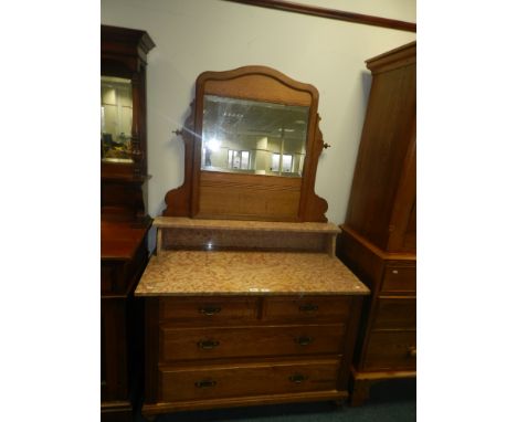 A late Victorian light oak marble top and mirror back washstand.**