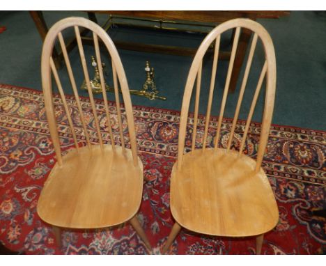 A pair of Ercol hoop and stick back beech framed chairs.