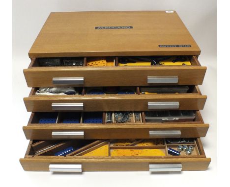 A Meccano No 10 Set, circa 1974, the set contained in four drawer veneered cabinet, many parts still attached to backing card