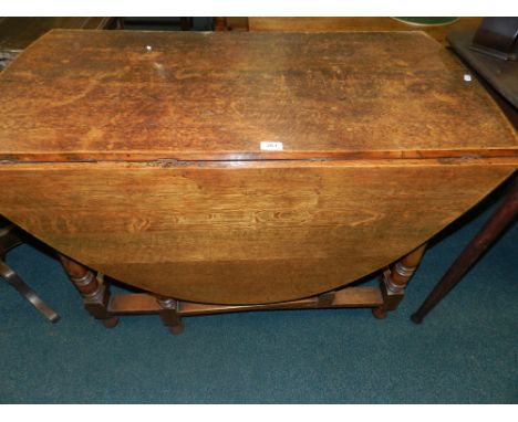 An early 20th century oak gate-leg dining table.*