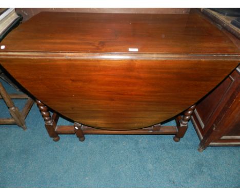 A 20th century gate leg dining table on barley twist supports (re-polished).*