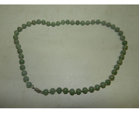 A uniform jade bead necklace.*