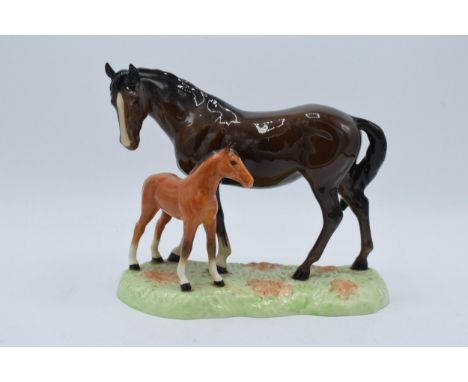 Beswick brown mare and chestnut foal on ceramic base 953  In good condition with no obvious damage though the horse's left ea