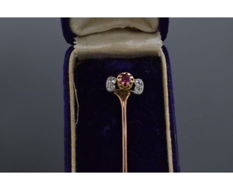 9ct gold diamond and ruby stick pin in case, 7.5cm long. 2.1 grams. 