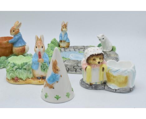 A collection of Beatrix Potter ceramic items to include 5 x Enesco egg cups, an Enesco soap dish, Border Fine Arts Studio cru