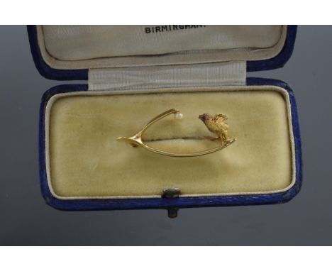 15ct gold wishbone brooch set single pearl and a standing chick with ruby eye, 2.8g, 33cm wide.  