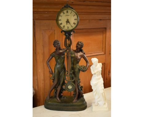 A contemporary Julianna Studios swinging mantle clock in the form of 2 ladies in robes holding it together with a resin Greek