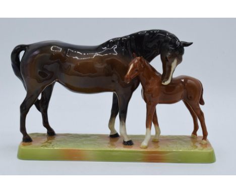 Beswick brown mare and chestnut foal on ceramic base 1811  In good condition with no obvious damage or restoration.