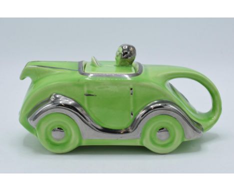 A 1930s Art Deco Sadler racing car teapot in lime green glaze with silvered detailing Reg No 820236, 22cm long.  In good cond