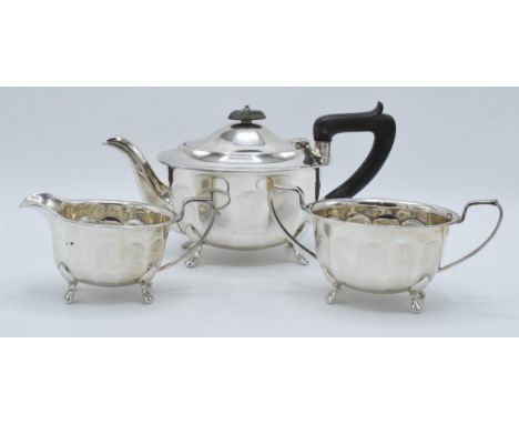 A silver 3-piece tea set to include a teapot with ebonised handle, sugar bowl and milk jug (3). Gross weight 937.0 grams. She