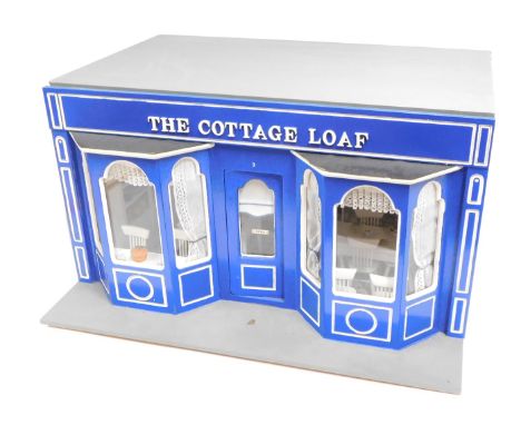 A model of The Cottage Loaf Cafe, 1:12 scale, with two bay windows, and other accessories. 