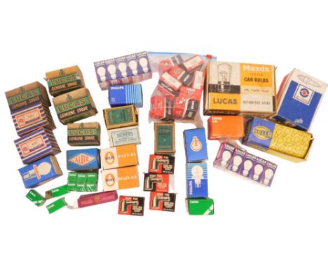 A group of automobile parts, to include Mazda, Philips, Lucas, and other bulbs and spark plug supressors. (1 tray) 