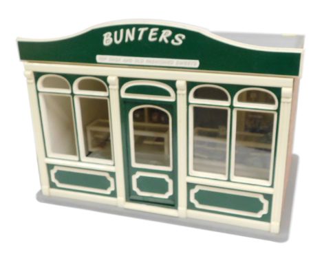 A model of Bunters Top Chocs and Old Fashion Sweets shop, 1:12 scale, with cabinets, furniture and other accessories. 