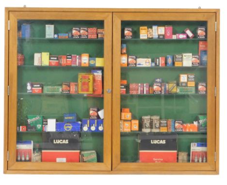 A group of automobile lights, bulbs and spark plugs, to include Lucas, Remax, Ring, Rival, Osram and others, in a presentatio