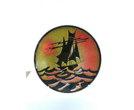 A Poole Pottery Aegean charger, shape 5, depicting a Yacht within a Sunset by L. J. Wills (14 inches diameter).