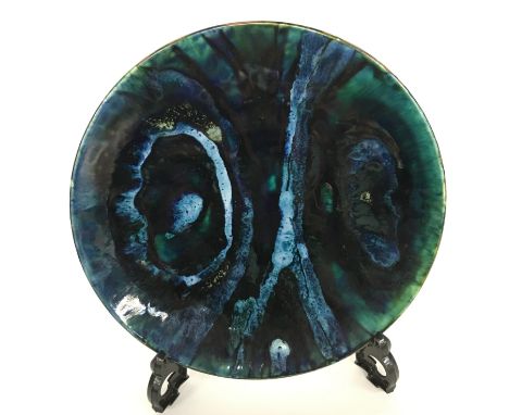 A Poole Pottery Studio dish in an Abstract design in deep blue/green lustrous glaze (8 inches diameter).