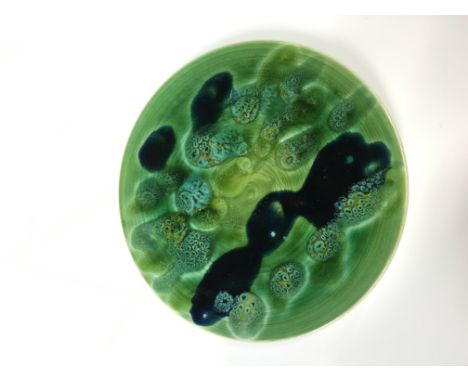 A good early Poole Pottery Studio pin dish, shape 49, in early green/black glaze (5 inches diameter).