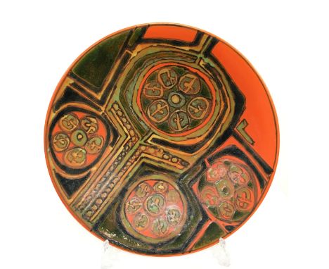 An early Poole Pottery Delphis charger in an abstract design in green and orange glazes by Christine Tate (16 inches).