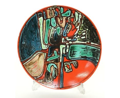 A Poole Pottery Delphis dish, bold abstract design in early glazes, decorated by Angela Wyburgh, shape 5 (14 inches diameter)