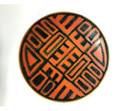 A Poole Pottery Studio Delphis early period dish, decorated in an Abstract design in black on an orange ground (10 inches dia