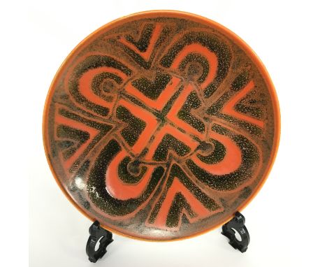 A Poole Pottery Studio dish in an Abstract design in early textured glazes (8 inches diameter).