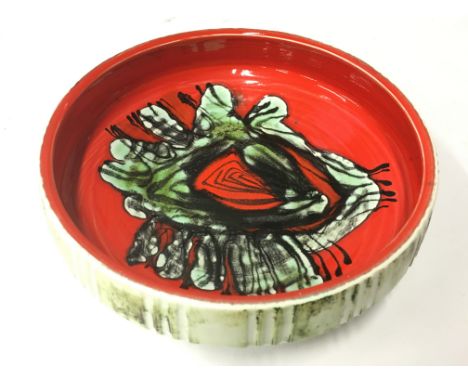 A Poole Pottery Delphis early earthenware dish, shape 89, carved and glazed with a decorated well by Jean Millership (11 inch