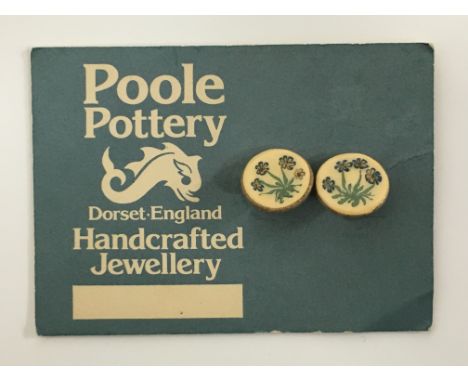 Poole Pottery handcrafted Jewellery.  A pair of stoneware clip earrings with floral hand painted design on original shop disp