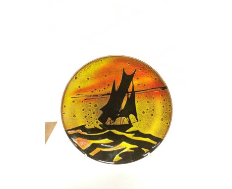 A Poole Pottery Aegean charger, shape 5, depicting a Yacht within a Sunrise (14 inches diameter).