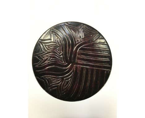 An early Poole Pottery Delphis dish, carved and glazed by Carole Holden (10 inches diameter).