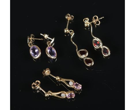 A pair of 9ct gold ruby and diamond drop earrings with two other pairs of earrings one set with amethyst the other garnets3.2