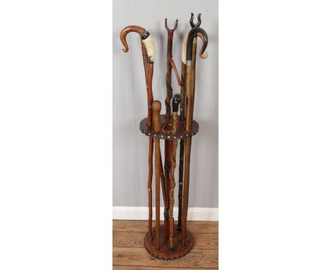 Eight Wooden Walking Sticks in Stand, with various design of head handles like Horn or Leather (Stand height 78cm diameter 30