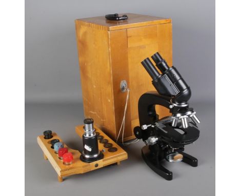 A cased Russian AY-12 CCCP binocular microscope with fitted tray containing ten lenses of varying sizes.