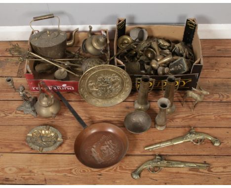 A large quantity of brassware including a pair of trench art style vases, brass animals including deer, pistol wall plaques, 