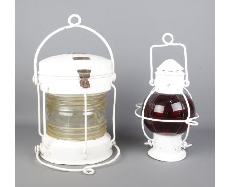 Two white painted signalling lanterns, to include Meteorite ships lantern, 'Anchor' 139386, alongside one other with bulbous 