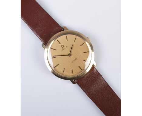 A gents 9ct gold Omega De Ville manual wristwatch. Having champagne dial and baton markers.  Running.