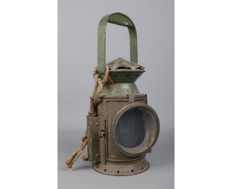 A WWII C. Eastgate &amp; Sons, Birmingham railway lantern. Dated 1943 and bearing broad arrow mark to the body. Height: 33cm.