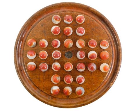 A wooden solitaire board with 32 glass red/white patch type marbles 16 mm, board 19.5 mm.