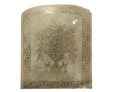 A Victorian arch form glass panel with etched decoration depicting a flower filled classical urn within foliate scroll border