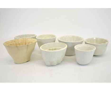 A collection of 19th century and later ceramic jelly moulds including one by Edge, Malkin &amp; Co, various forms and designs