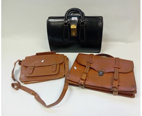Two vintage tan double belted leather satchels together with vintage leather briefcase with brass lock