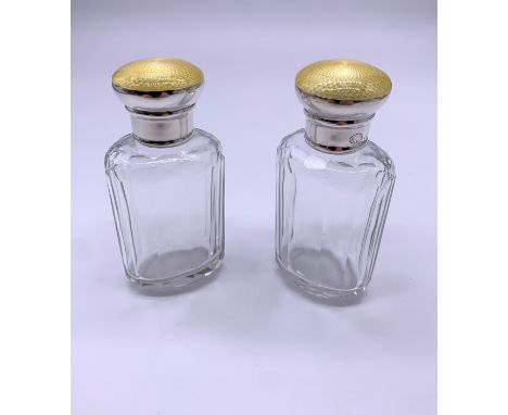 Pair of silver topped perfume bottles, engine turned yellow enamel tops c1915-1920