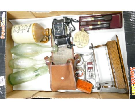 A mixed collection of items to include: vintage glass bottles, novelty musical stool, stanley compass, camera etc 