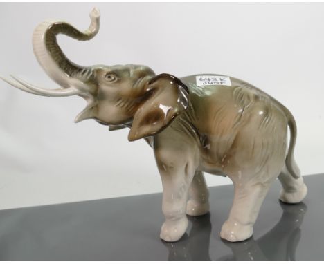 Royal Dux model of an elephant with trunk in salute : height 26cm. (tiny chip to end of one tusk)